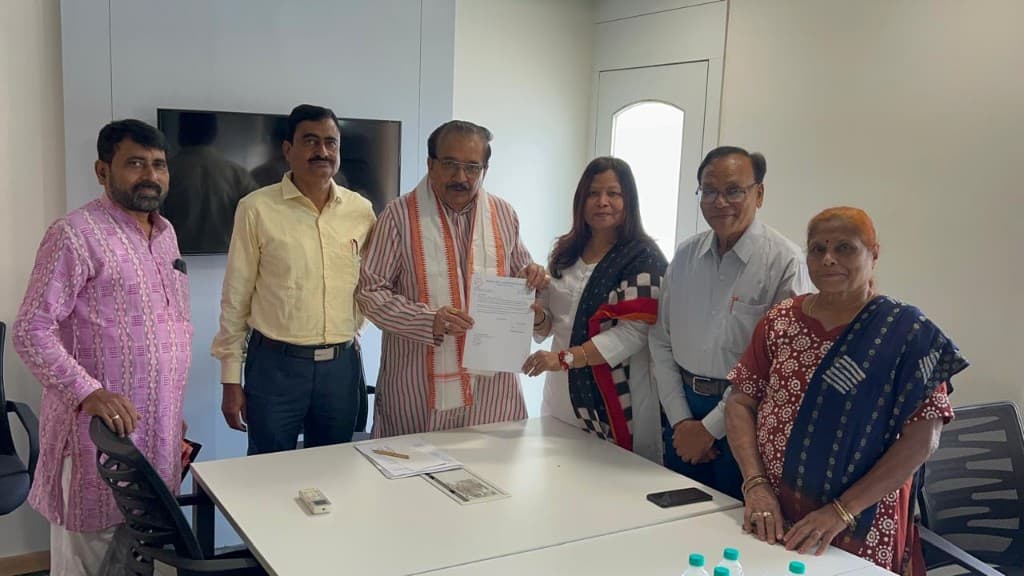 Formal document presentation with Smt. Nibedita Nayak Baliarsingh and BKS Odisha colleagues.