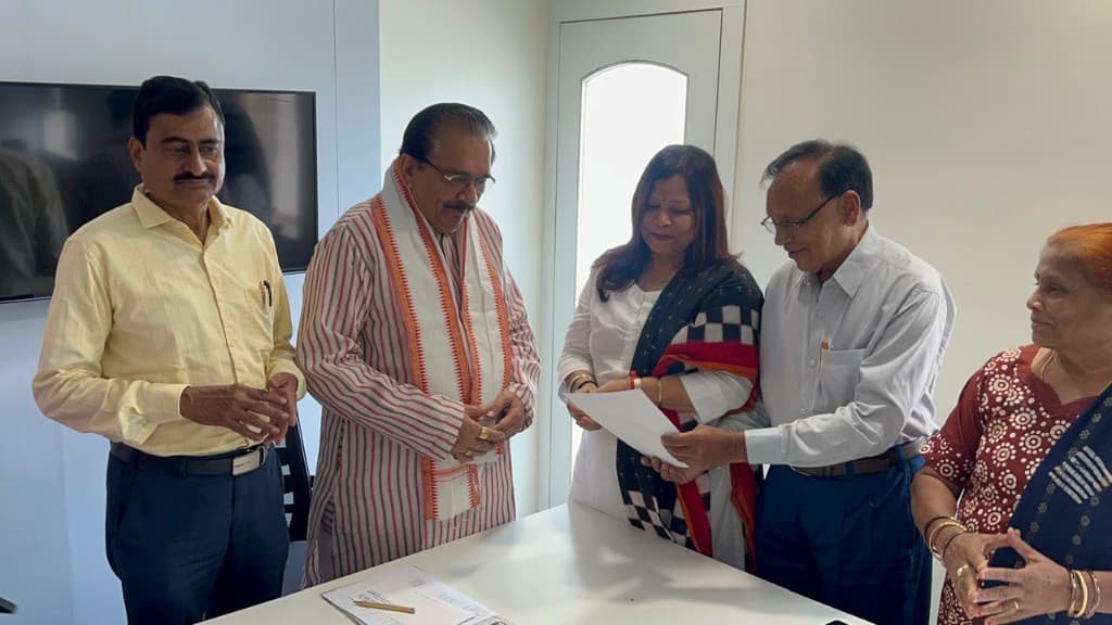Leadership meeting — reviewing an official document with BKS Odisha representatives.